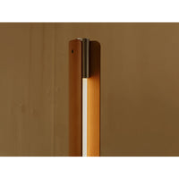 Close-up detail of Flos Seki-Han floor lamp, featuring a warm wood frame, integrated illuminated diffuser, and brushed metal accent at the top.